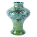 A Moorcroft pottery Claremont pattern vase, decorated overall with mushrooms in green, on a