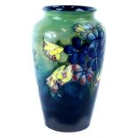 A Moorcroft pottery Spring Flowers pattern vase, decorated with flowers on a mottled blue and
