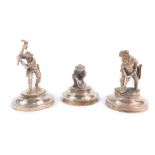 Three place setting holders modelled as gold prospectors, each raised on a circular base, stamped