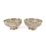 A pair of Victorian silver footed bowls, embossed with flowers and scrolling leaves, William