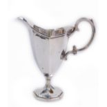 A Victorian Adam style silver cream jug, of octagonal baluster form with double scroll handle, Henry