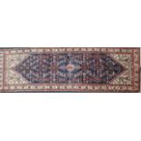 A near pair of Takoma small rugs, red ground, each 105cm x 50cm.