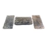 Three Chinese silver tablets, one embossed with dragons, another with a pheasant and lion dog, the