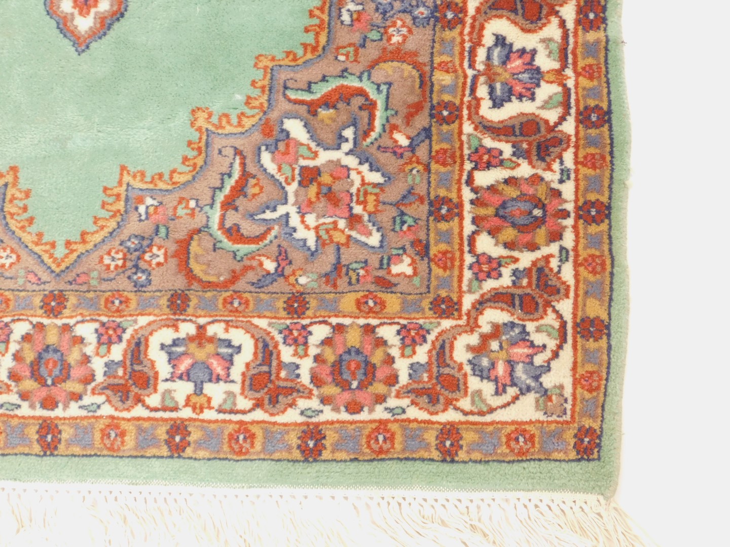 A Caucasian rug, possibly Ushak, decorated with a central medallion against a green ground within - Image 2 of 3