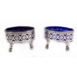 A pair of George IV silver oval salts, decorated with a band of pierced flower heads, reserve