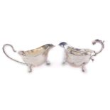 A George V silver sauce boat, with double scroll handle, raised on three hoofed feet, Chester