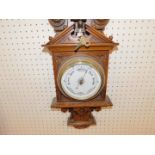 A Victorian oak cased clock and barometer, with thermometer, the case of carved classical