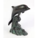 A bronze figure of a dolphin, modelled riding on the crest of a wave, 16cm H.