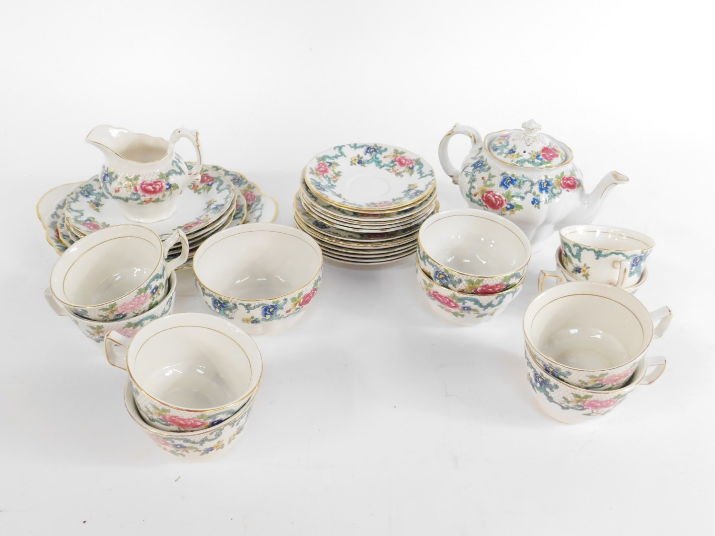 A Royal Doulton and Booths pottery and porcelain part tea service, decorated in the Floradora