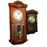 Two wall clocks, to include a 1920's example, refinished in a stained case.Provenance: This