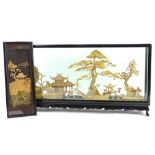 An oriental cork picture, modelled in the form of trees, storks, buildings etc., in ebonised