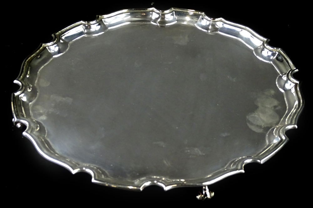 An Elizabeth II silver salver, with a piecrust border and scroll feet, Sheffield 1967, retailed by