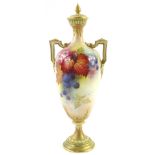 A Royal Worcester porcelain two handled vase and cover, decorated with autumn leaves, blackberries