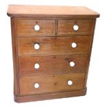 A Victorian stripped pine chest of two short three long drawers, on a plinth base, with ceramic