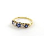 An 18ct gold sapphire and diamond five stone ring, the ring head set with three round brilliant