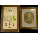 Three First World War medals, associated to a V H Richardson of the Coldstream Guards, framed with a