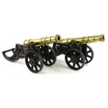 A pair of turned brass canon, the barrels 39cm L, each on a cast iron trunnion.