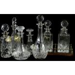 A collection of cut glass decanters and stoppers, each of differing form, to include a pair
