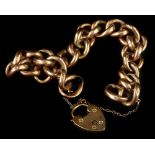 A 9ct gold charm bracelet, with chunky curb links and heart shaped padlock, with safety chain, 23g