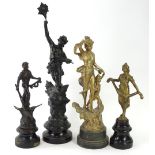 Various spelter figures, to include one example of a figure standing on the world, on ebonised base,