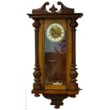 A Vienna wall clock, in a walnut case, the enamel type dial with pressed decoration of a angels,