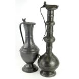 A large pewter flagon, with Middle Eastern influences, the slender neck terminating in a hinged