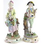 A pair of German porcelain figurines, each modelled in the form of musician and a lady carrying