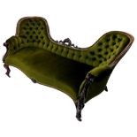 A Victorian rosewood settee, with a moulded pierced and carved show frame, upholstered in green