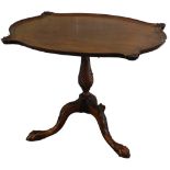 A mahogany occasional table, the rectangular top with a serpentine pie crust type border, with shell