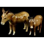 Two Beswick donkeys, the largest 14cm H.