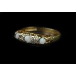 A 9ct gold gypsy ring, set with imitation opal and tiny white stones, in scroll design ring head,