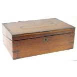 A 19thC teak and brass bound campaign type writing box, the hinged lid with a vacant cartouche,