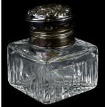 A George VI cut glass inkwell, the hinged silver lid embossed with scrolls etc., Birmingham 1943.