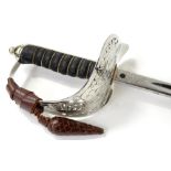 A George V dress sword, with an engraved blade, shark skin handle and pierced guard, housed within a