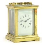 A French small brass carriage timepiece, the white enamel dial with Roman numerals, 9cm H.