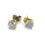 A pair of diamond stud earrings, each stone approximately 0.3cts, in yellow metal claw setting,