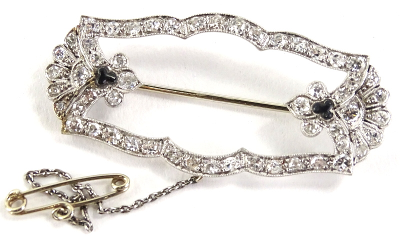 A diamond and sapphire Art Deco brooch, the design set with tiny diamonds, with a fan to each end,