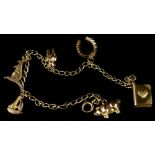 A charm bracelet, with six charms including a pig, boat, kangaroo, bear, horse shoe and book, yellow