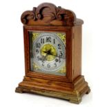 A German mantel clock in oak case, the square dial with Arabic numerals, signed RL Cozens Taunton,