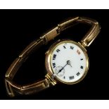 A 9ct gold wristwatch, with circular white enamel watch head, in 9ct gold casing on expanding 9ct