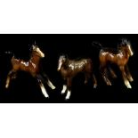 Three Beswick brown foals, the tallest 12cm H.