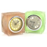 Two similar Art Deco carriage type timepieces, each with a moulded glass case, in the manner of