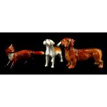 Three Beswick animals, a Daschund, a small fox and a Beagle.