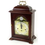 A German mahogany mantel clock in George III style, the arched dial inscribed Tempus Fugit above