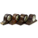 Four oak cased napoleons hat mantel clocks, to include one with Westminster chime. (AF)Provenance: