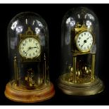 Two early 20thC brass anniversary type clocks, each with an enamel dial, decorated with Roman