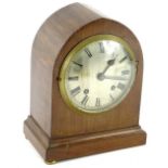 An Edwardian mahogany and chequer banded lancet shaped mantel clock, the silvered dial with Roman