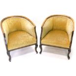 A pair of early 20thC beech tub shaped chairs, upholstered in beige fabric on cabriole legs.