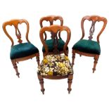 A set of four Victorian mahogany balloon back chairs, each with a padded seat, on turned tapering