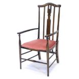 An Edwardian beech boxwood strung and inlaid elbow chair, with a padded seat, on turned tapering
